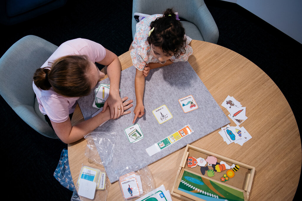 Woman engaging in teaching, sharing knowledge with a young girl