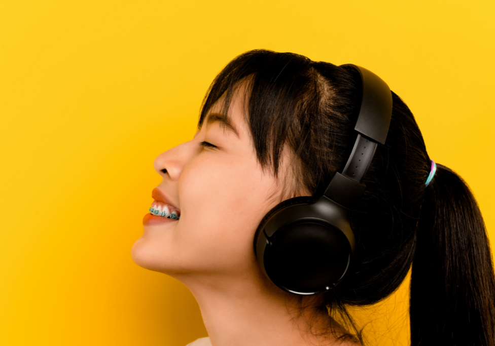 woman listening to the music with headphones