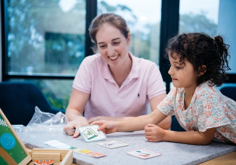 adult and child playing cards