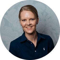 Smiling woman in a dark blue business casual outfit